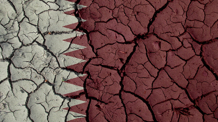 mud cracked dry ground with qatar flag